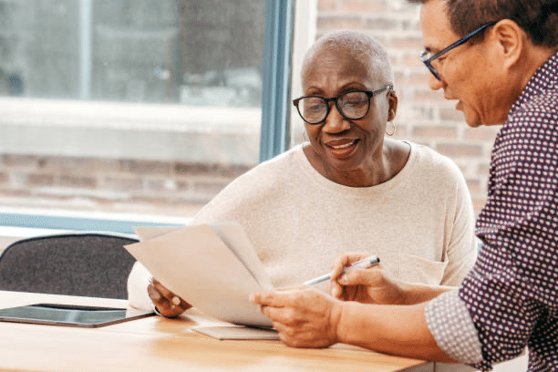 older woman reviewing document with man